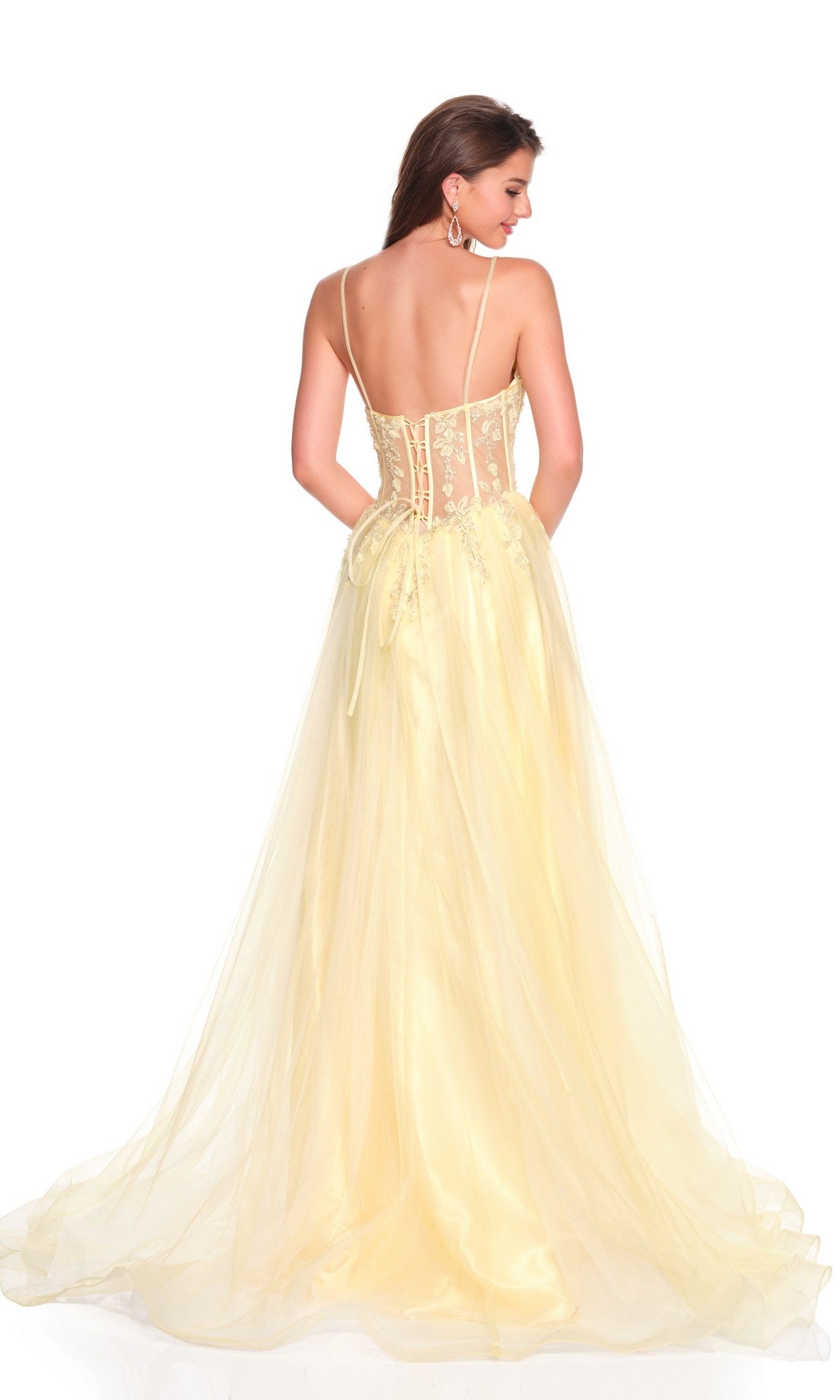 A woman faces away from the camera wearing the Dave and Johnny 12424 long prom dress, featuring an a-line yellow skirt, sleeveless design, sheer back, and lace detailing.